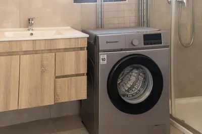 a washing machine in a bathroom next to a sink at Atlantic Sal Ocean View in Santa Maria
