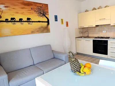 a living room with a couch and a bowl of fruit on a table at Boadream Casa Duria Porta Rossa in Prainha