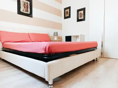 a bedroom with a large bed with red sheets at Boadream Casa Duria Porta Rossa in Prainha