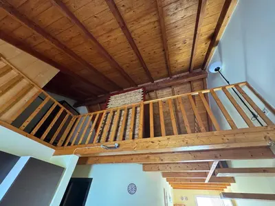 a staircase in a house with wooden ceilings at Holiday Properties Prestige Apartments in Santa Maria