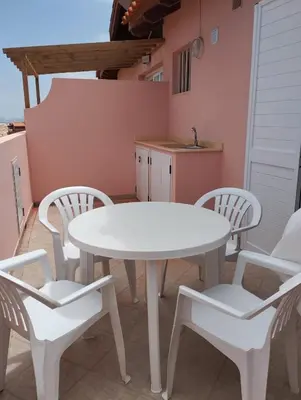 a white table and four chairs in a kitchen at Holiday Properties Prestige Apartments in Santa Maria