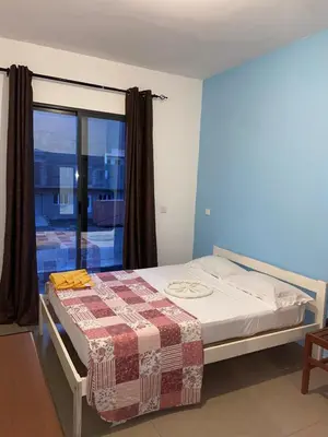 a bed in a room with a window at Kaza Horta in Tarrafal