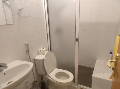 a bathroom with a toilet and a sink and a shower at Kaza Horta in Tarrafal