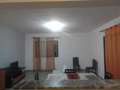 a bedroom with a bed and a television and a room at Kaza Horta in Tarrafal