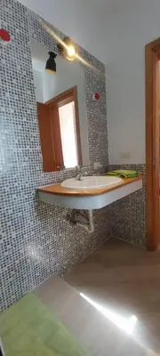 a bathroom with a sink and a mirror at Cala da Lua apartments in Sal Rei