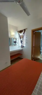 a room with a kitchen with a ceiling fan at Cala da Lua apartments in Sal Rei