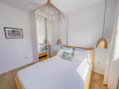 a bedroom with a large white bed with two pillows at Helena - Marel Bliss Apartments T3 in Mindelo