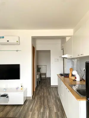 a kitchen with white cabinets and a counter top at MaRiRa Apartments T1 in Santa Maria
