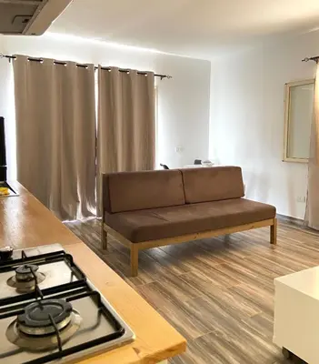 a living room with a couch and a stove at MaRiRa Apartments T1 in Santa Maria