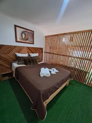 a bedroom with a bed with two white shoes on it at Bangaló Buzio Relax in Portal