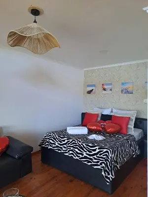 a bedroom with a bed with red pillows on it at Bangaló Buzio Relax in Portal