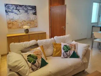 a couch with pillows on it in a living room at Apartamento Silva 1 in Praia