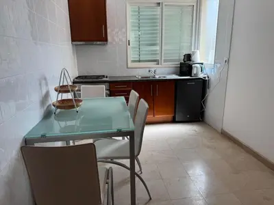 a kitchen with a table and chairs and a sink at Apartamento Silva 1 in Praia