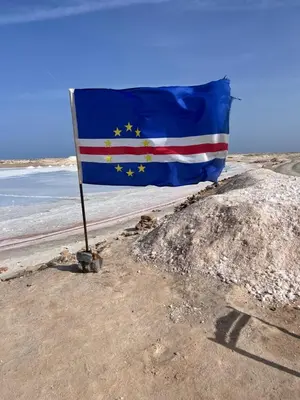 a flag on a beach with the european flag at Appartement moderne au paradis in Santa Maria