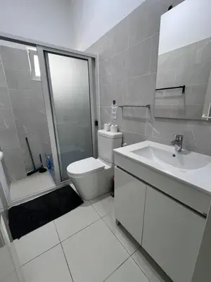 a white bathroom with a toilet and a sink at Appartement moderne au paradis in Santa Maria