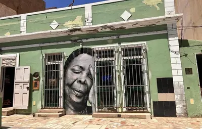 a building with a large face painted on the side of it at Appartement moderne au paradis in Santa Maria