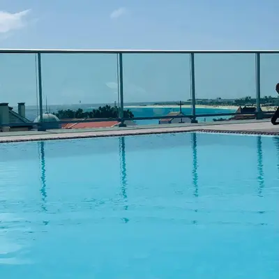 a swimming pool with blue water in front of a building at Sal Little Heart Bia Apartment 19 in Santa Maria