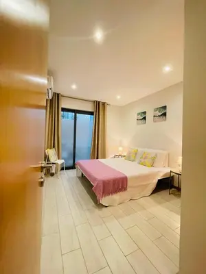 a bedroom with a bed and a large window at Sal Little Heart Bia Apartment 19 in Santa Maria