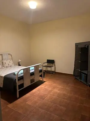a bedroom with a bed and a chair in it at Casa azul in Mindelo