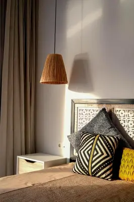 a bedroom with a bed with a pillow and a lamp at Marina Mindelo Bay View in Mindelo