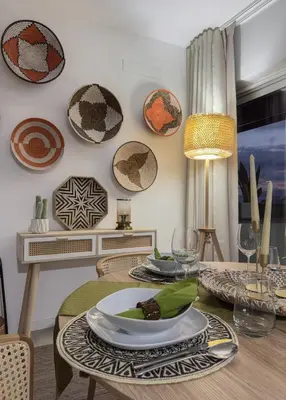 a dining room with plates and glasses on a table at Marina Mindelo Bay View in Mindelo