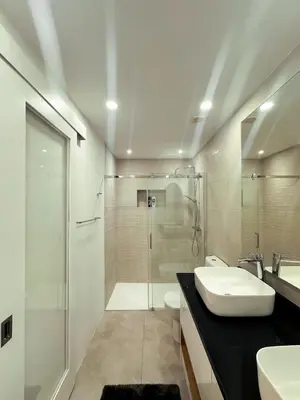 a bathroom with a shower and a sink and a toilet at Marina Mindelo Bay View in Mindelo