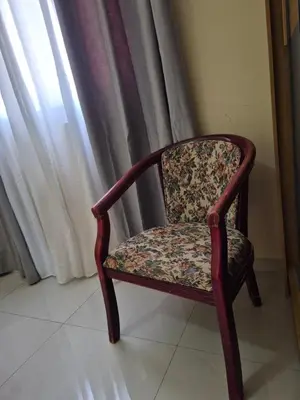 a chair sitting in front of a window at Casa di Morabeza in Praia
