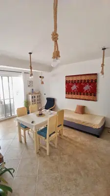 a living room with a table and chairs and a couch at Alma MIRIAM in Sal Rei