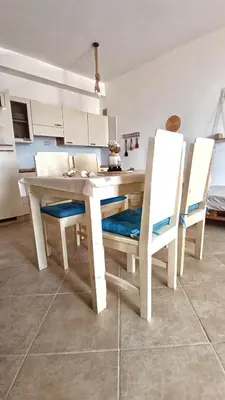 a kitchen with a wooden table and two chairs at Alma MIRIAM in Sal Rei