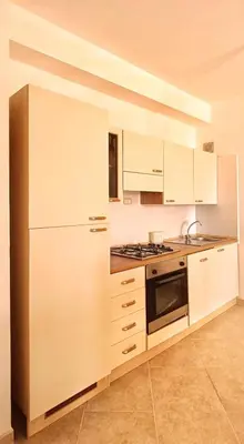 a kitchen with white cabinets and a stove at Alma MIRIAM in Sal Rei