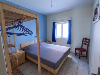a bedroom with a bunk bed and a chair at Kasa Amizade in Prainha
