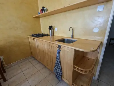 a kitchen with a sink and a wooden counter at Kasa Amizade in Prainha