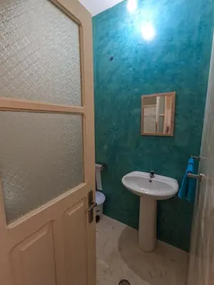 a bathroom with a white sink and a toilet at Kasa Amizade in Prainha