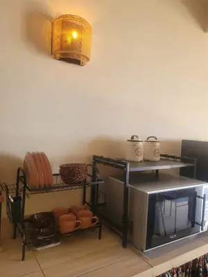 a kitchen with a microwave and some pots and pans at Lovely Seaview Apartment Magnolia in Santa Maria