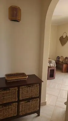 a room with a table and baskets on a floor at Lovely Seaview Apartment Magnolia in Santa Maria