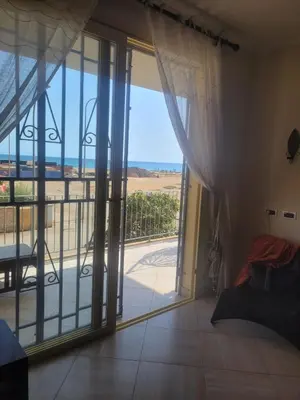 a room with a sliding glass door with a view of the ocean at Lovely Seaview Apartment Magnolia in Santa Maria