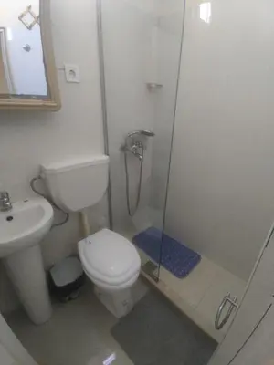 a bathroom with a shower and a toilet and a sink at Apartamentos Sossego in Praia