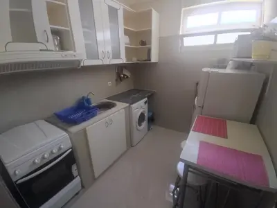 a small kitchen with a sink and a refrigerator at Apartamentos Sossego in Praia
