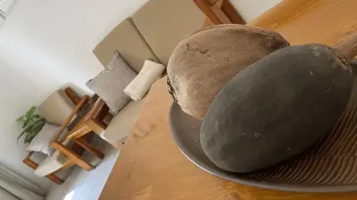 two melons on a plate on a table at Apartament Salim in Beirona