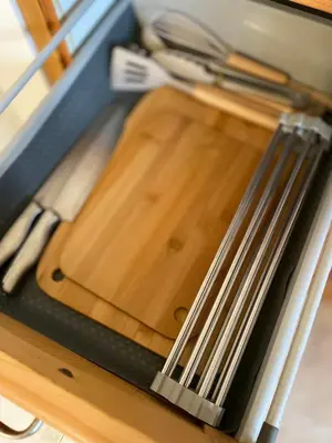 a wooden cutting board with utensils on a table at Apartament Salim in Beirona