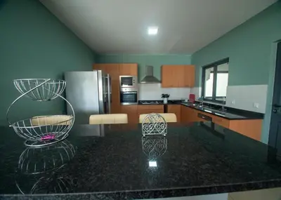 a kitchen with a black counter top in a room at Apartamentos Octane Mindelo in Mindelo