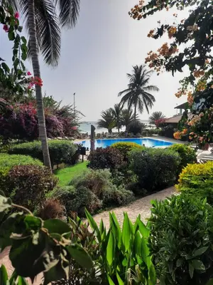 a resort with a swimming pool and palm trees at Porto Antigo 2 Beach Club 18 in Santa Maria