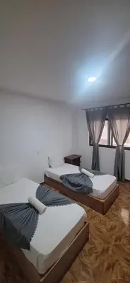 three beds sitting in a room with a window at Morabeza Serena in Santa Maria