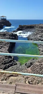 a pool of water on the rocks near the ocean at Morabeza Serena in Santa Maria