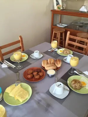 a table with plates of food and glasses of orange juice at Hotel POUSADA Brava in Vila Nova Sintra