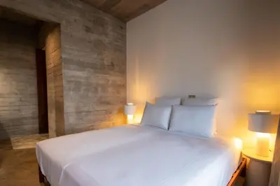 a large white bed in a room with two lamps at Villa - Vue Mer et Piscine Privée in Mindelo