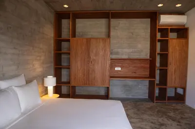 a bedroom with a white bed and wooden shelves at Villa - Vue Mer et Piscine Privée in Mindelo