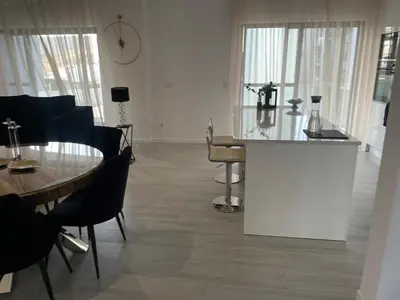 a living room with a table and a table and chairs at Grace apartamento T2 in Praia