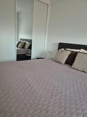 a bedroom with a bed and a couch in it at Grace apartamento T2 in Praia