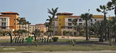 a park with palm trees and buildings in the background at Apartamento mj in Santa Maria